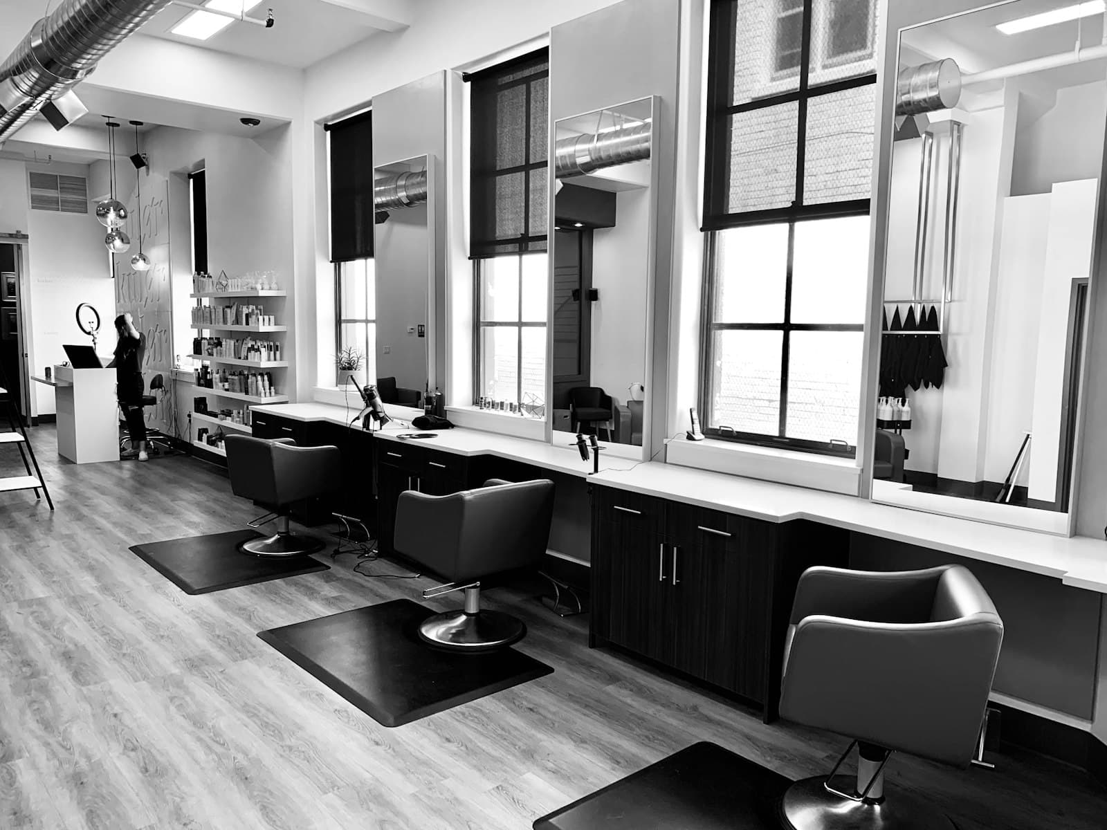 A row of chairs in a modern hair salon